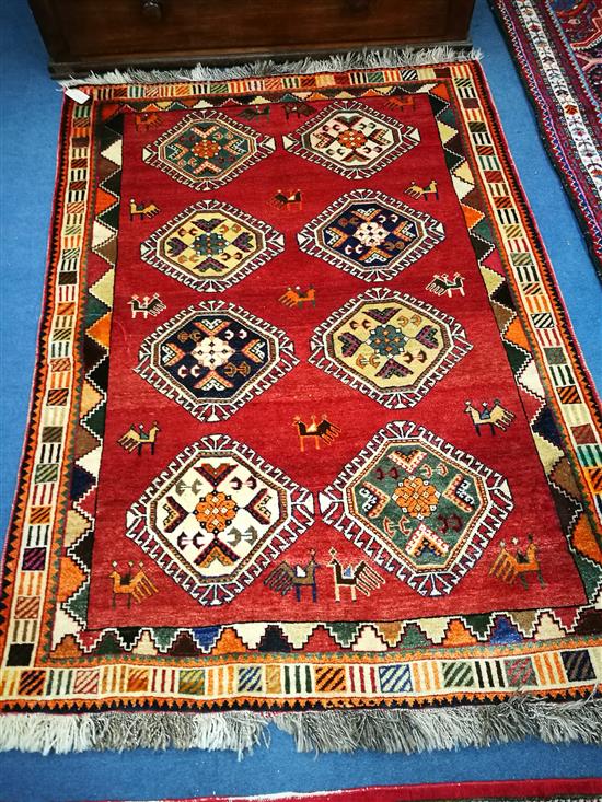 A Quashgai brick red ground geometric rug 175 x125 cm